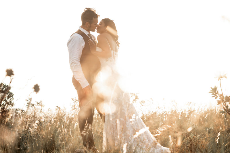 A couple celebrating their wedding in golden light